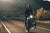 man doing a wheelie on a motorcycle on the road during sunset