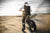 shot of motorcyclist from behind in the sand